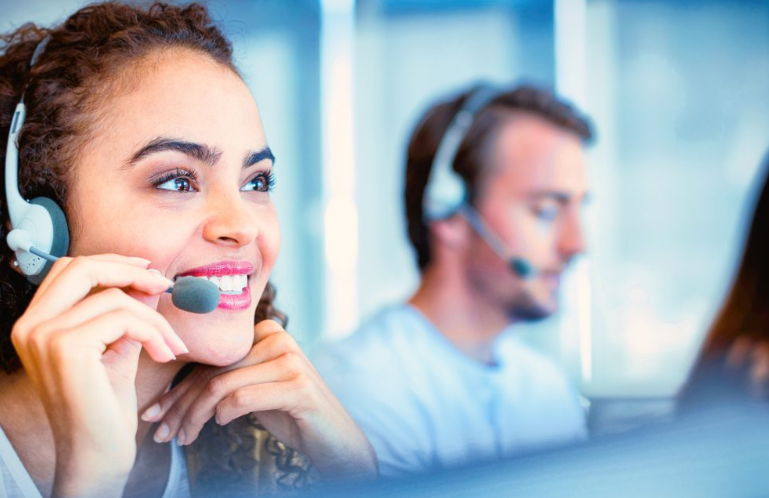  A Picture of a Woman and Men wearing Headphones in a Call Center 